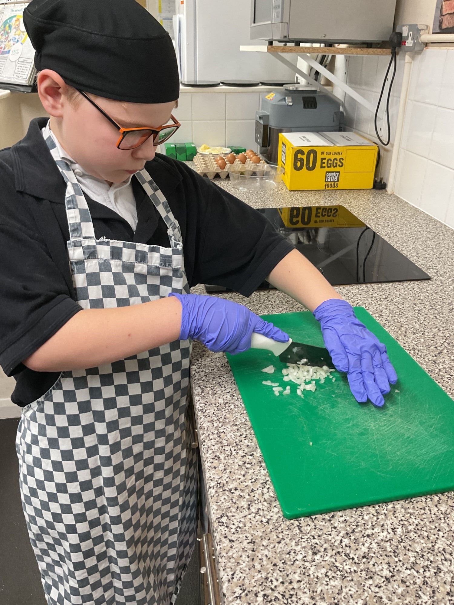 Elm student chopping onion