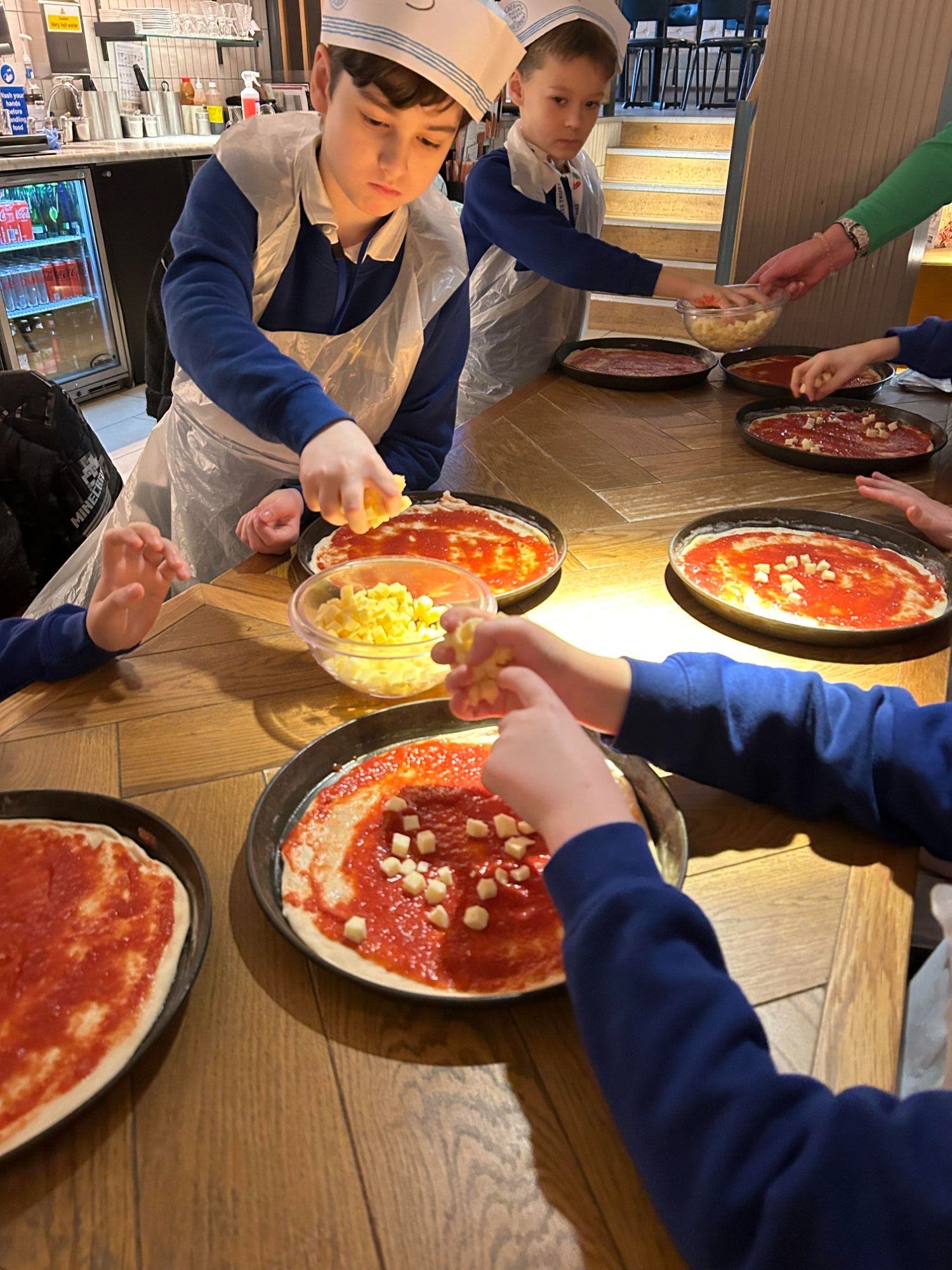 Students making their pizzas